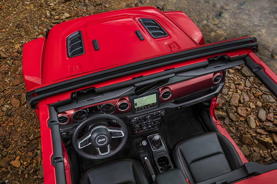 vue en plongée donnant sur les sièges avant, le tableau de bord et le volant du Jeep Wrangler 2021